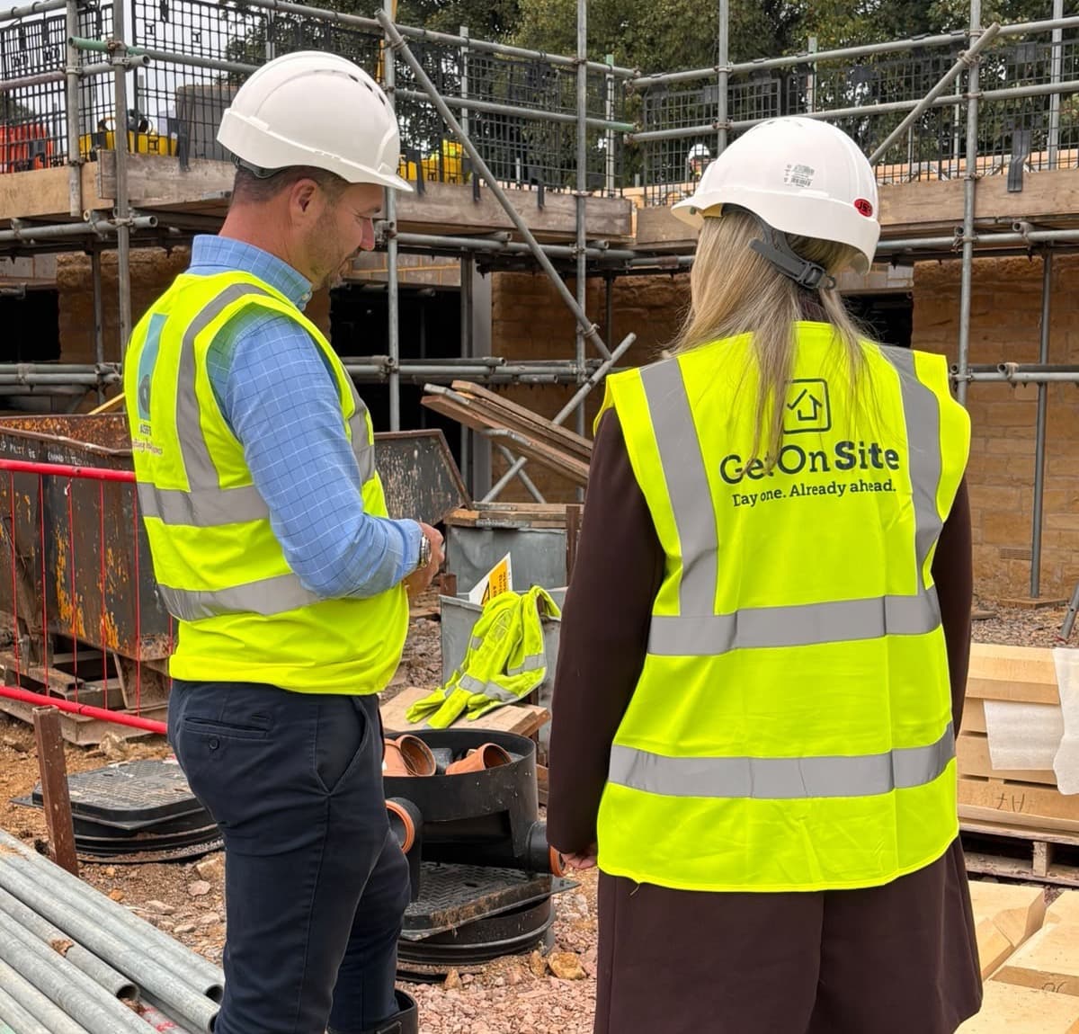 A site manager and a GetOnSite team member reviewing work on a building site
