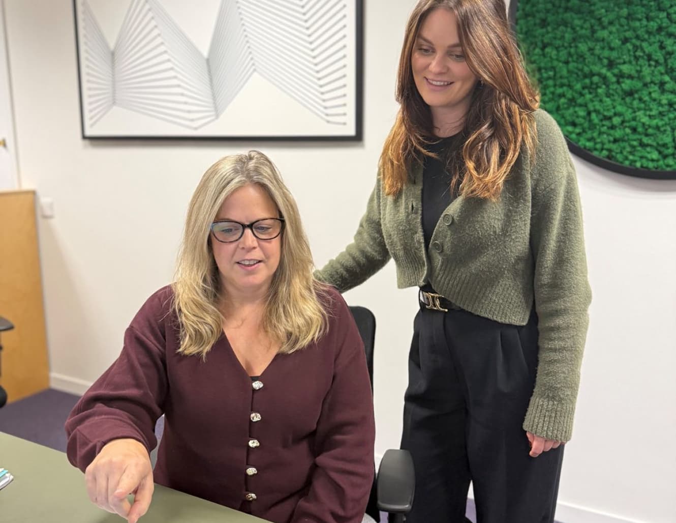 Two members of the GetOnSite support team at a desk